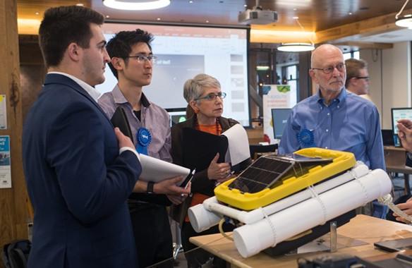 A U N E student presenting to judges at the Student Innovation Challenge event